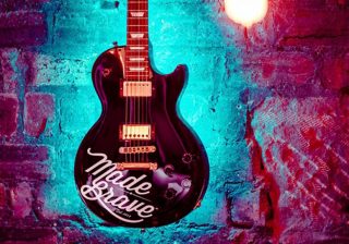 Guitar with the MadeBrave logo