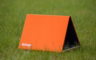 Vango booklet on grass; closed to look like a tent.