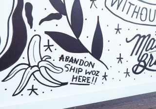 Hand-painted, Mexican themed drawings on a wall, with the phrase “Abandon Ship Woz Here”.