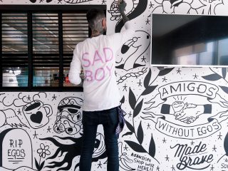 employer-branding-amigos Richard from Abandon Ship painting the wall mural for Amgos Without Egos