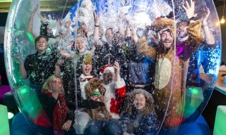 Winter Wonderland The MadeBrave Team stands inside an inflatable snow globe