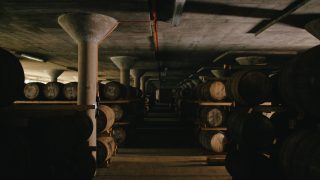 Deanston warehouse showing several whisky barrels