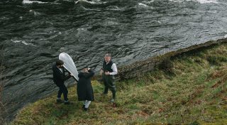 Behind the scenes of shooting man in front of a river