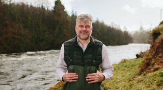Man standing in front of a river