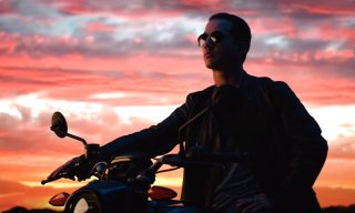 Virtual Production - Is It the Next Big Thing for Brands? Man sitting on a motorcycle with sunset in the background