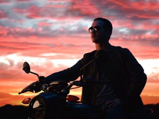 Virtual Production - Is It the Next Big Thing for Brands? Man sitting on a motorcycle with sunset in the background
