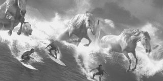Guiness Surfer Ad by AMV BBDO Black and white photo of men surfing in the waves with horses