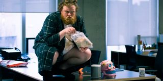 Kev Eating Lucky Charms Kev squatting on a desk eating Lucky Charms