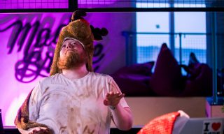 Zoom Christmas Dance Party A man dancing with a rudolph the red nose reindeer costume