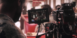 camera person focusing on actors on virtual production sound stage