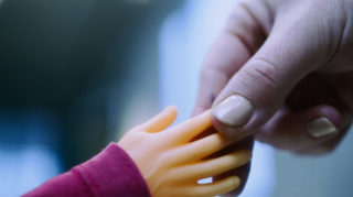 Giant Handshake regular hand shaking a rubber tiny hand