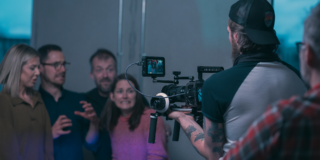 Behind the Scenes - Scream Scene man holding a camera filming several people