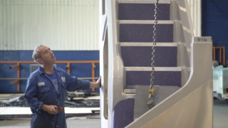 Photo of man installing stairs for New Buses Assembly