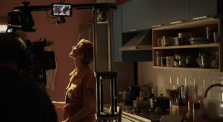 behind the scenes - woman looking up at light