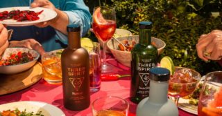 People around a table enjoying food and non alcoholic drinks