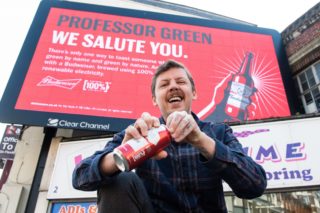 Professer green in front of the Budweiser renewable energy billboard ad