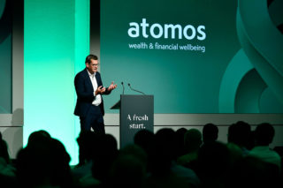 photo of Jonathan Polin, CEO of atomos on a stage with green background