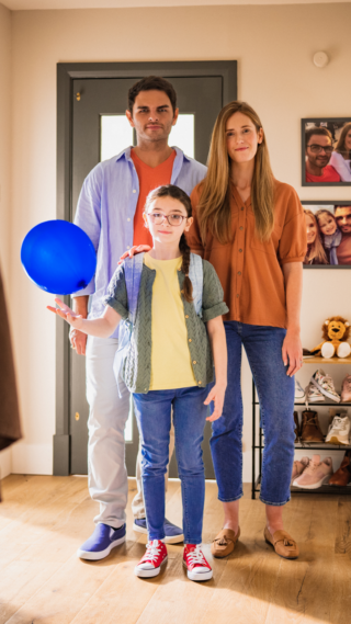 Blue Balloon Campaign - Global photo of a little girl keeping a balloon in the air with her parents standing behind her