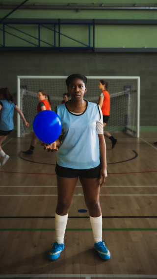 Blue Balloon Campaign - Global photo of a woman holding a blue balloon while standing in a gym