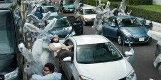 A super bowl commercial still of a dozen bunnies dragging people out of their cars