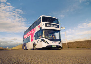 First Bus rolling into bus stop to pick up main character.