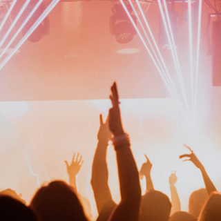 photo of people dancing with orange and red lights