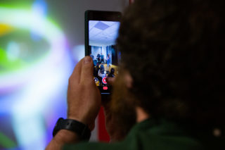 a photo of a man taking a photo with an iphone at the D&AD New Gen Awards