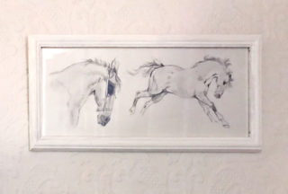 photo of a framed drawing of two horses