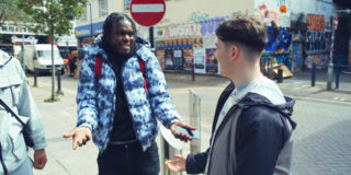 Google - Hands Raised photo of two men talking on the street