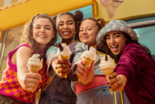 a photo of 4 young women with ice cream cones