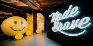 CreatorMashup - Entrance photo of the entrance to the creatormashup which includes a giant smiley face, 200 yellow balloons, and the white madebrave sign