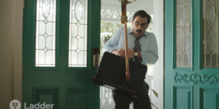 still frame from an ad showing a man surprised to see an ax has just been stuck into his briefcase