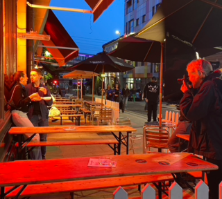 behind the scenes photo of a couple outside of a restaurant