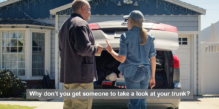 still frame of a woman with long hair and jeans arguing with a man in front of a car