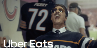 Super Bowl LIX - Uber Eats still frame of a man in sunglasses and a Bears jersey laughing with