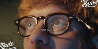 Watch Our Showreel zoomed in photo of a man wearing glasses looking into the distance with