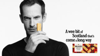 Andy Murray Gets Brand Distinctiveness - Do You? a black and white photo of andy murray holding up a piece of walkers shortbread