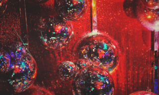 The Marketing Society Amplify Festival photo of several disco balls with red light cast on them