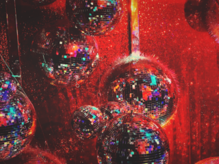 The Marketing Society Amplify Festival photo of several disco balls with red light cast on them