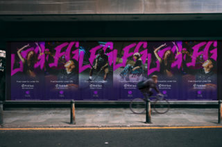 A photo of a street and sidewalk with several posters of LFG in pink