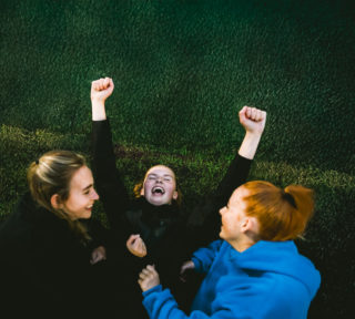 Fist Bus LFG Campaign - Skills photo of three young women celebrating with hands over their head