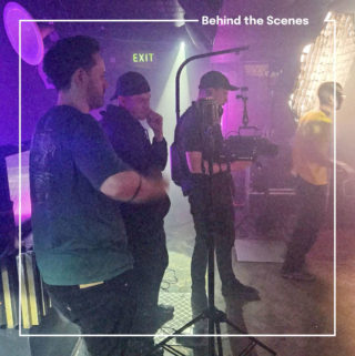 Fist Bus LFG Campaign - BTS a behind the scenes photo of a production crew shooting the LFG campaign with pink light washing across the background