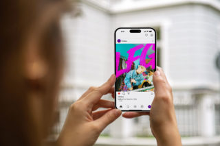 Fist Bus LFG Campaign - Mobile Ad photo of a person holding an iphone with an LFG ad in pink showing on the screen