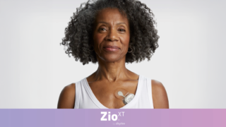 Putting Zio™ at the Heart of Monitoring photo of a woman wearing a white tank top and a Zio device from iRhythm