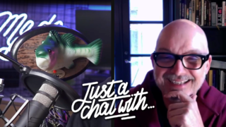 a photo of a billy the bass fish and a man laughing. 'Just a chat with' is overlayed in white