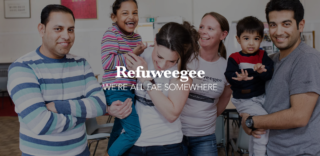 image of a woman holding a child with other people standing around smiling. White text overlayed says 