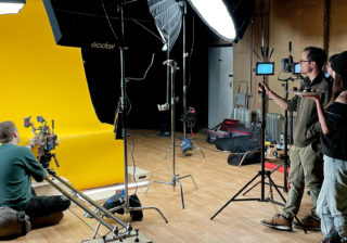 Tunnock's Brand Film - Behind the Scenes a photo of two people setting up a shot with production equipment for the tunnock's brand film