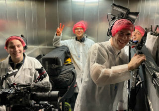 Tunnock's Brand Film - Behind the Scenes a photo of a film crew riding the lift inside the tunnocks factory