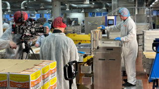 Tunnock's Brand Film - Behind the Scenes a photo of a tunnocks employee being filmed working inside the tunnocks factory