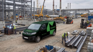 Coriant Construction Site a photo of a green van with coriant logo on the side, sitting amongst a construction site